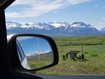 View of landscape seen through car windshield