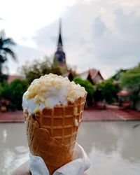 Close-up of hand holding ice cream cone