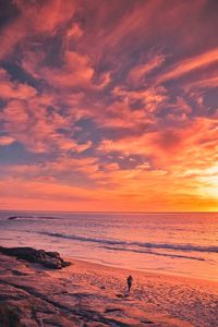 Scenic view of sea against orange sky