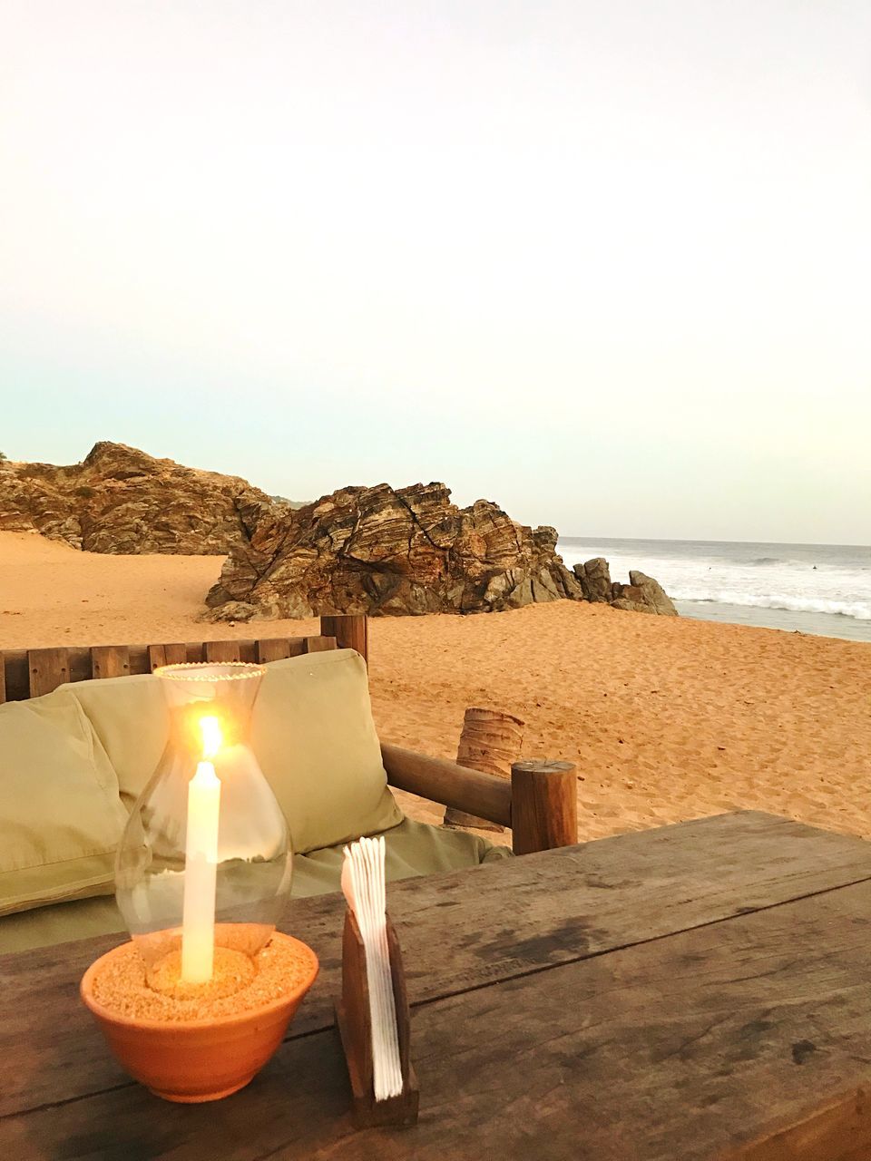 sea, table, beach, sand, candle, clear sky, rock - object, no people, tranquility, nature, water, outdoors, sky, day