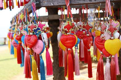 Close-up of various decorations hanging for sale in market