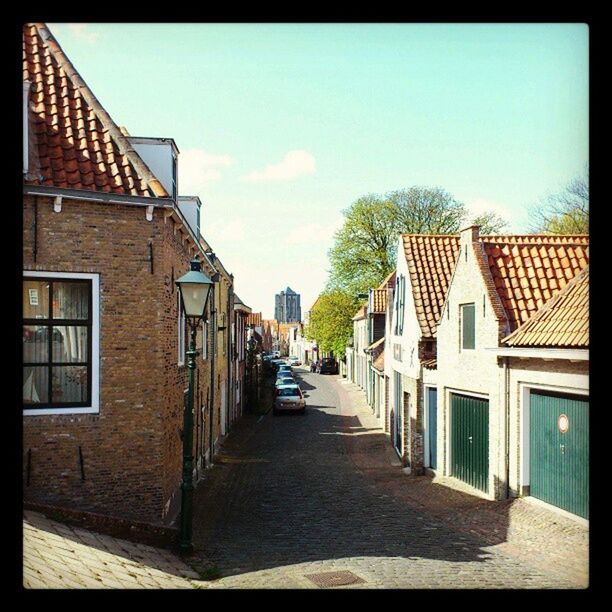 building exterior, architecture, built structure, the way forward, house, residential structure, transfer print, residential building, street, sky, diminishing perspective, sunlight, auto post production filter, city, narrow, building, town, cobblestone, alley, empty