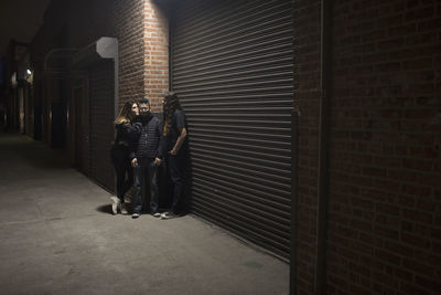 Band posing for portrait on a street at night
