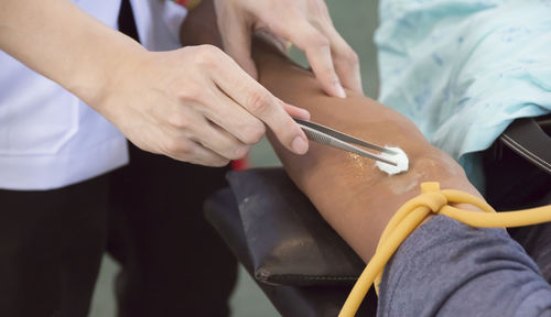 Close-up of doctor treating patient