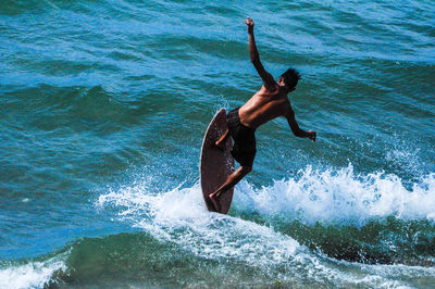 Full length of shirtless man in sea