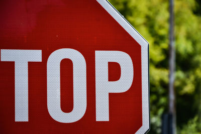 Close-up of sign on fence