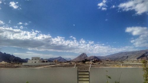 Scenic view of mountains against blue sky