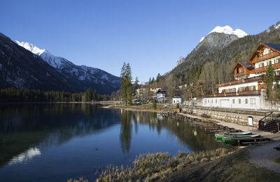 Scenic view of lake and mountains against clear sky