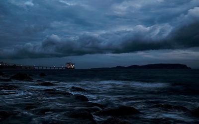 Scenic view of sea against cloudy sky