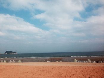 Scenic view of sea against cloudy sky