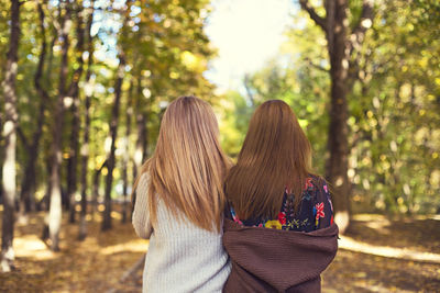 Rear view of couple kissing in forest