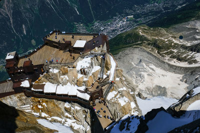 High angle view of snow covered buildings and mountains