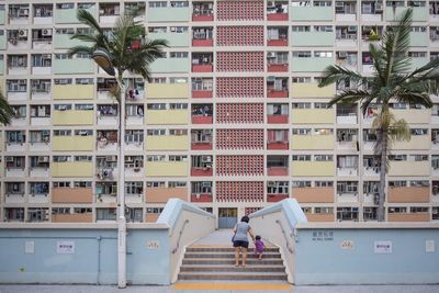 Woman with umbrella in front of buildings