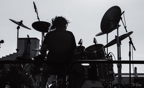 Rear view of man sitting on stage