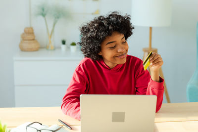 Young woman using laptop at home