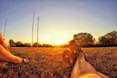 Low section of people relaxing on field