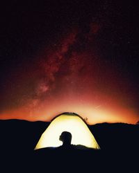 Silhouette man against sky at night