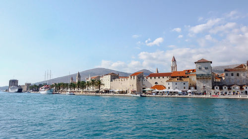 View of sea against buildings in city