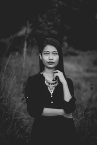 Smiling young woman standing on field