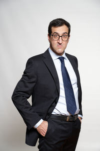 Portrait of man standing against white background