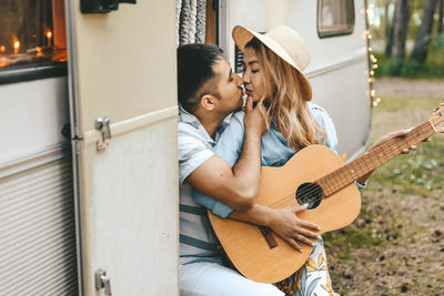 Married asian couple in love travel by camper car on a road trip in nature on their honeymoon