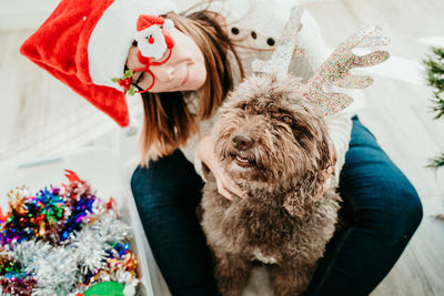 Portrait of woman with dog at home