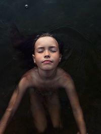 Portrait of young woman swimming in sea