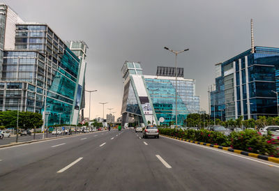 City street and modern buildings against sky