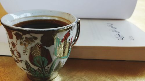 Close-up of coffee cup on table