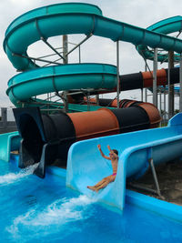 Full length of girl enjoying water slide in park