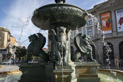 Low angle view of statue against building