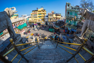 People standing in city against clear sky