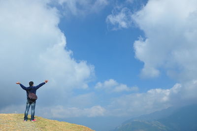 Full length of man standing on landscape against sky