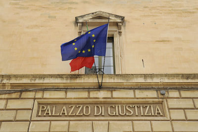 Low angle view of flag against building