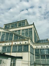 Low angle view of building against cloudy sky