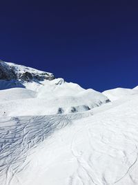 Scenic view of snow covered mountains against clear sky