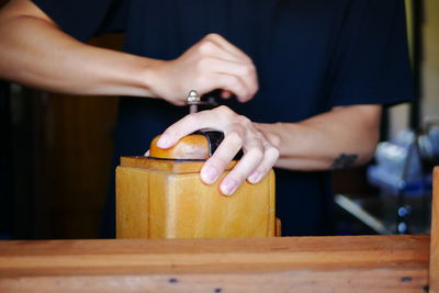 Midsection of man working on table