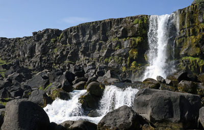 A large waterfall over a rocky cliff - Öxaráfoss in thingvellir national park.