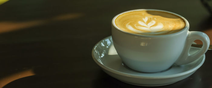 Close-up of cappuccino served on table