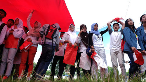 Group of people in traditional clothing standing outdoors