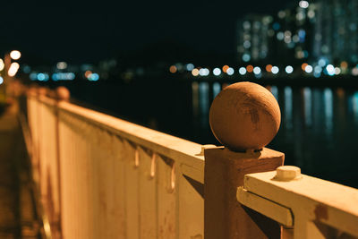 Close-up of illuminated railing at night