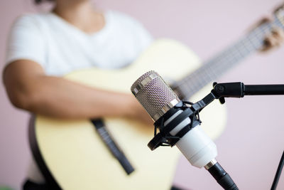 Close-up of man holding guitar