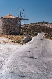 Road by land against clear sky