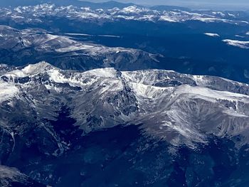 Aerial view of snowcapped mountains and sea