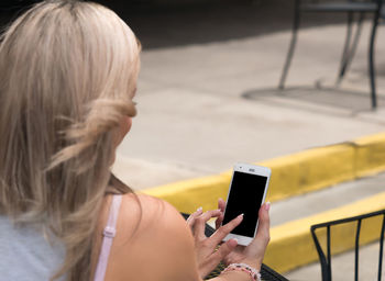 Rear view of woman using mobile phone