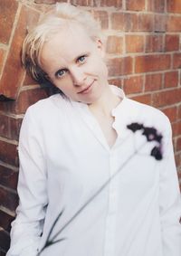 Portrait of teenage girl against wall