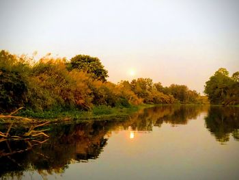 Scenic view of lake against sky during sunset