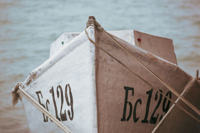 High angle view of text on wood against sea