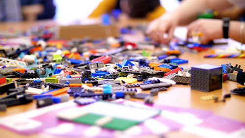 On the table there are scattered a lot of details from the children's designer, cubes, wires, boards