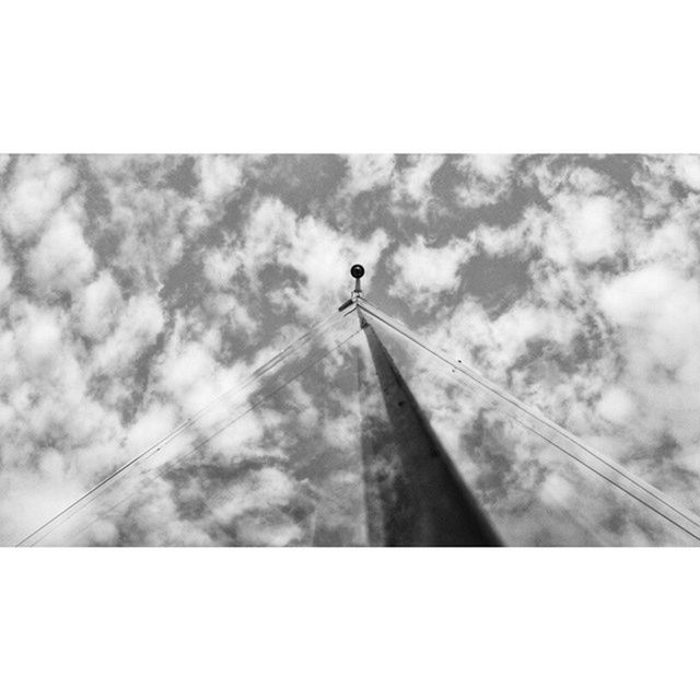 low angle view, transfer print, sky, auto post production filter, cloud - sky, cloud, day, outdoors, connection, cloudy, nature, silhouette, no people, cable, power line, bird, one animal, sunlight, tranquility, pole